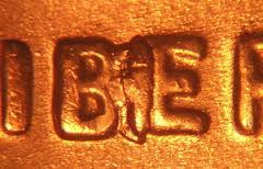 Close-up of 1932 wheat penny BIE error showing raised die break between B and E in LIBERTY resembling an extra letter I